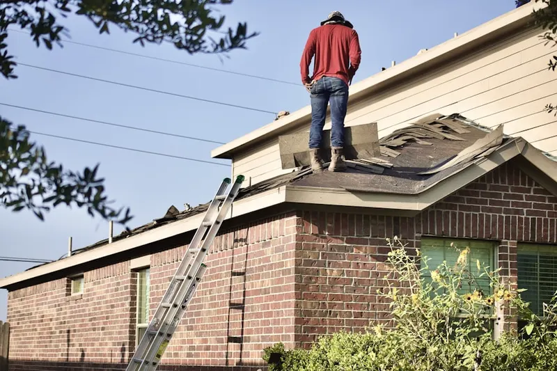 Professional roofer working on a residential roof in Oakhurst Manor